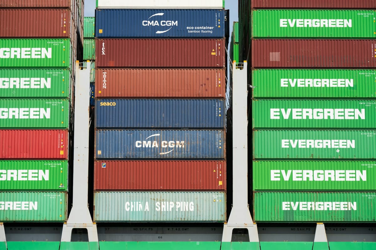 Stacked green, red, and blue shipping containers