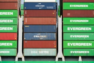 Stacked green, red, and blue shipping containers